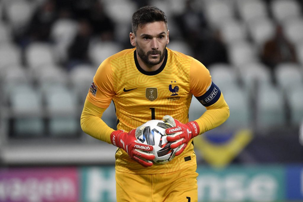 French goalkeeper Hugo Lloris in yellow jersey and red gloves grips ball focused during match Wallpaper