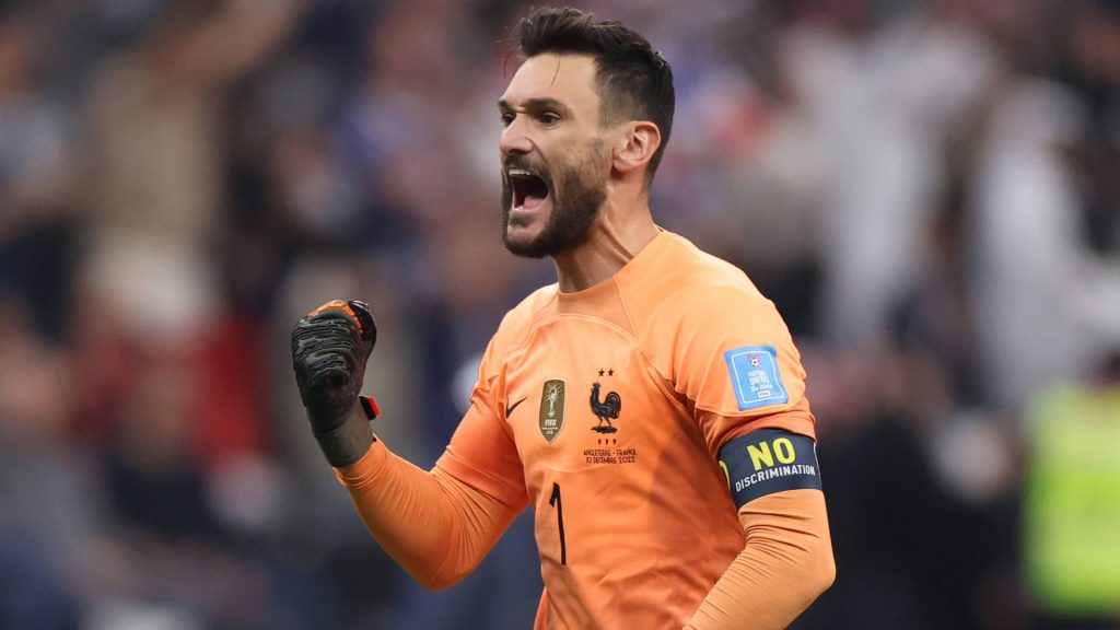 French goalkeeper Hugo Lloris yelling in orange kit with No Discrimination armband 2022 World Cup Wallpaper