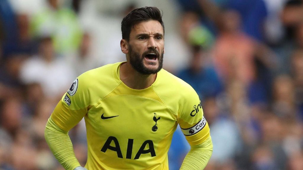 Close-up of goalkeeper Hugo Lloris shouting in bright yellow Tottenham Hotspur jersey stadium background Wallpaper