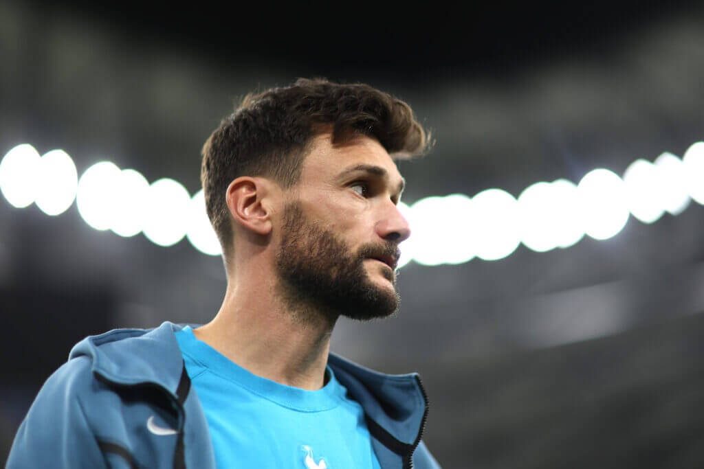 Close-up of focused French goalkeeper Hugo Lloris in blue kit with glowing stadium background Wallpaper