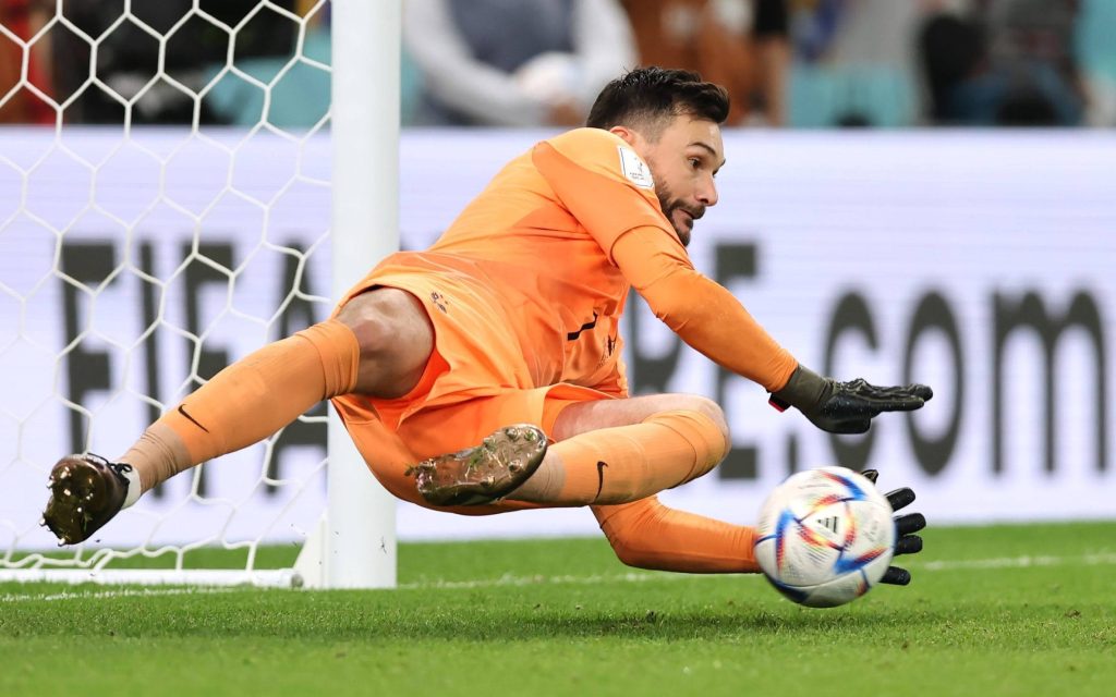 Hugo Lloris in orange kit diving save dynamic football action wallpaper background for fans