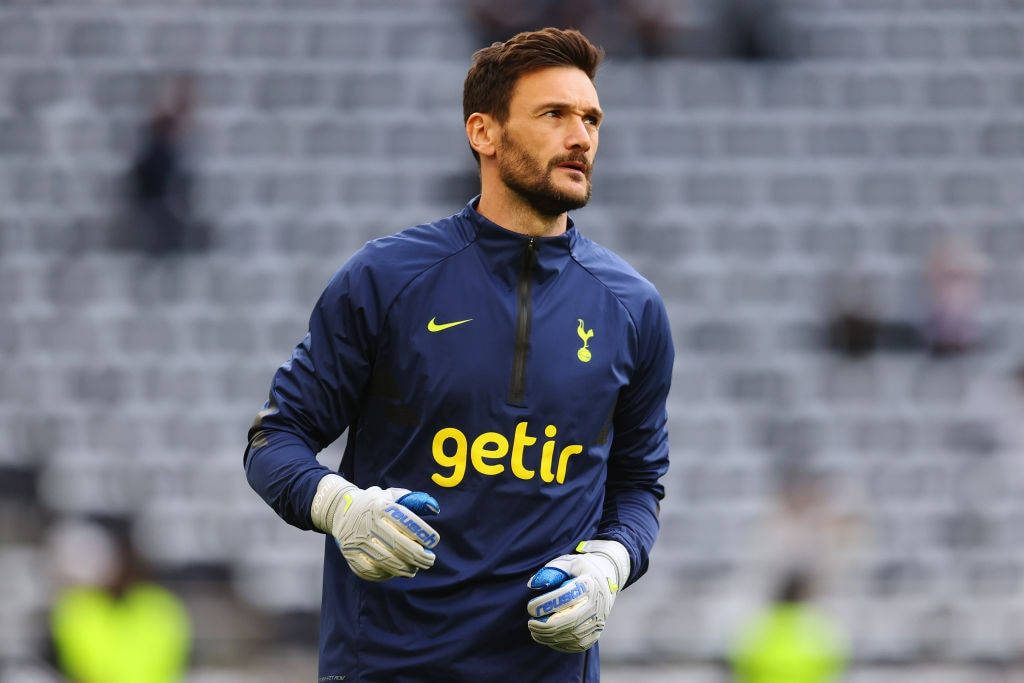 Goalkeeper Hugo Lloris in navy Tottenham kit with Reusch gloves focused in stadium background wallpaper