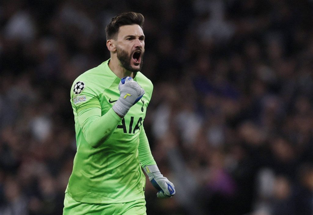 Hugo Lloris in neon green Tottenham kit fist-pumping passionately in stadium background wallpaper