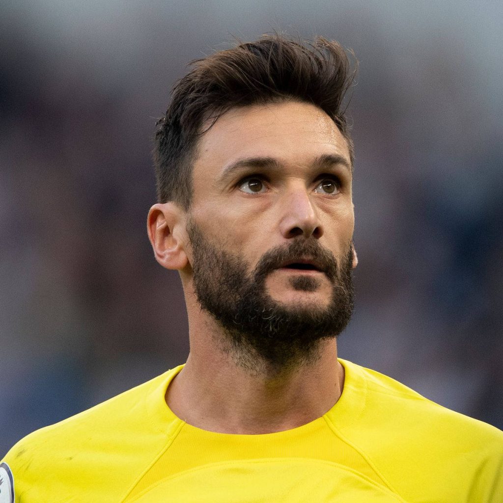 Hugo Lloris intense close-up in yellow goalkeeper kit sharp stadium background football wallpaper