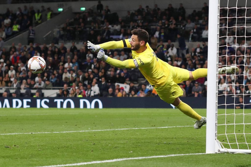 Hugo Lloris diving save in yellow kit football wallpaper dynamic stadium action background