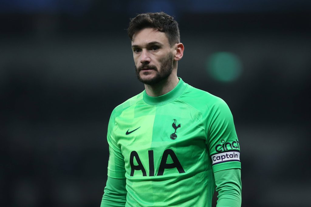 Hugo Lloris in neon green kit focused goalkeeper Spurs wallpaper dark stadium background