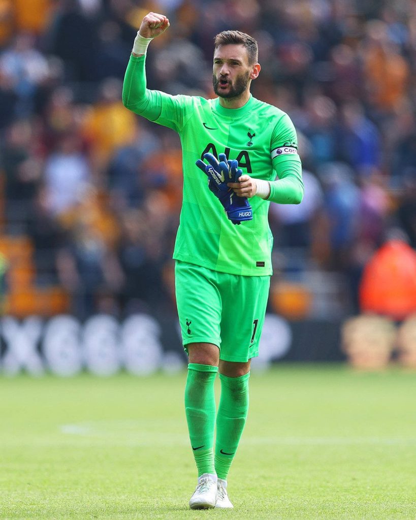 Hugo Lloris in neon green Tottenham kit celebrates with fist pump on football pitch wallpaper