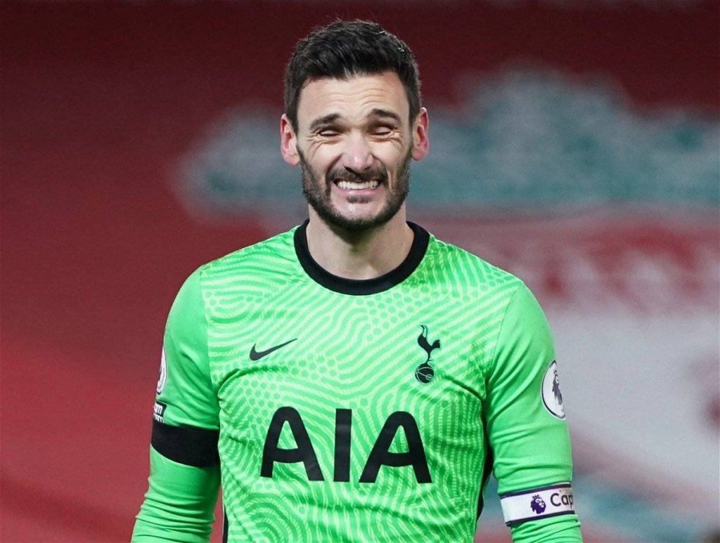 Hugo Lloris in neon green Tottenham kit showing intense expression in Premier League match Wallpaper