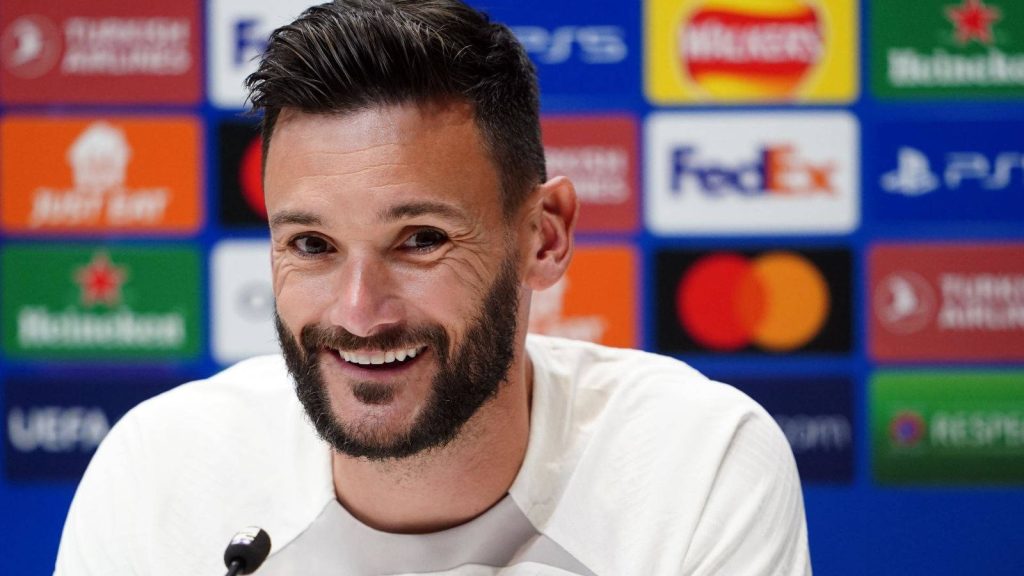 Hugo Lloris smiling at UEFA press conference in white shirt vivid football fan wallpaper background