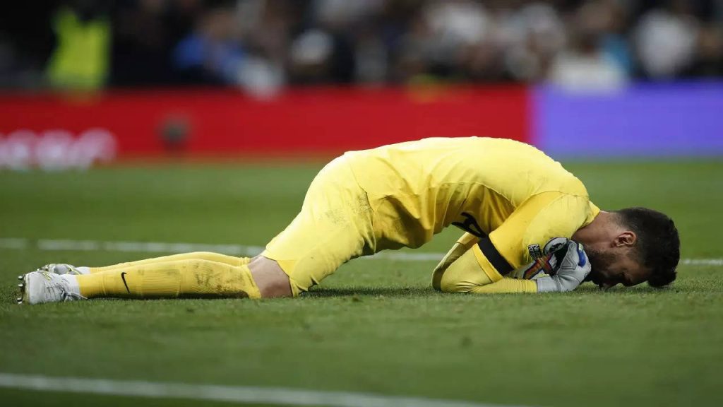Goalkeeper Hugo Lloris in neon yellow Tottenham kit face down on pitch showing sports disappointment Wallpaper