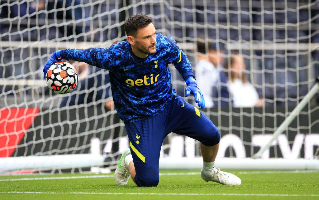 Tottenham Hotspur goalkeeper Hugo Lloris kneeling in blue kit preparing to toss football wallpaper