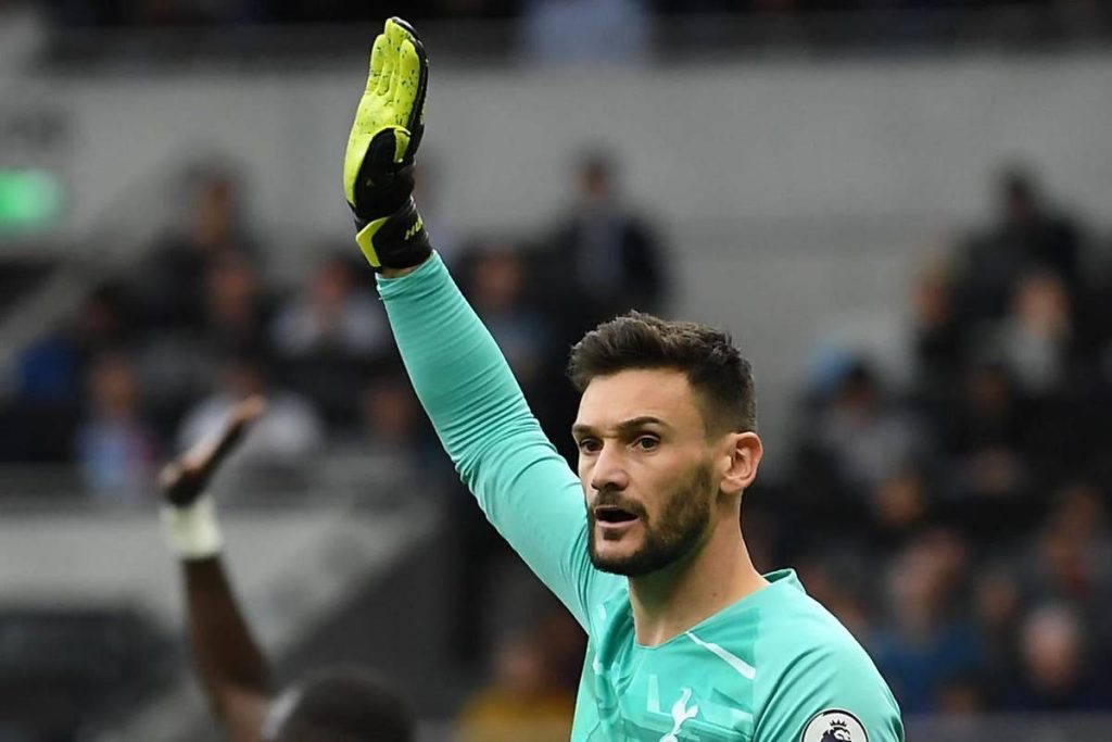 Hugo Lloris in teal Tottenham goalkeeper kit with raised hand intense sports wallpaper background
