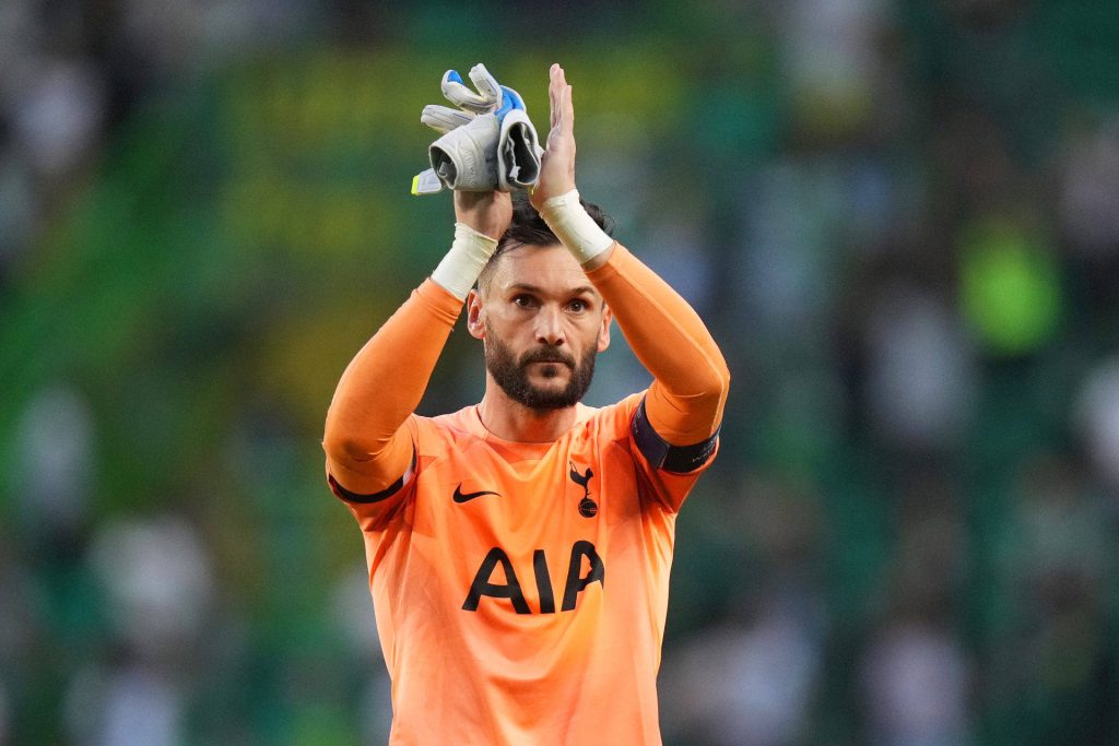 Hugo Lloris in bright orange Tottenham Hotspur kit applauding fans vibrant football wallpaper