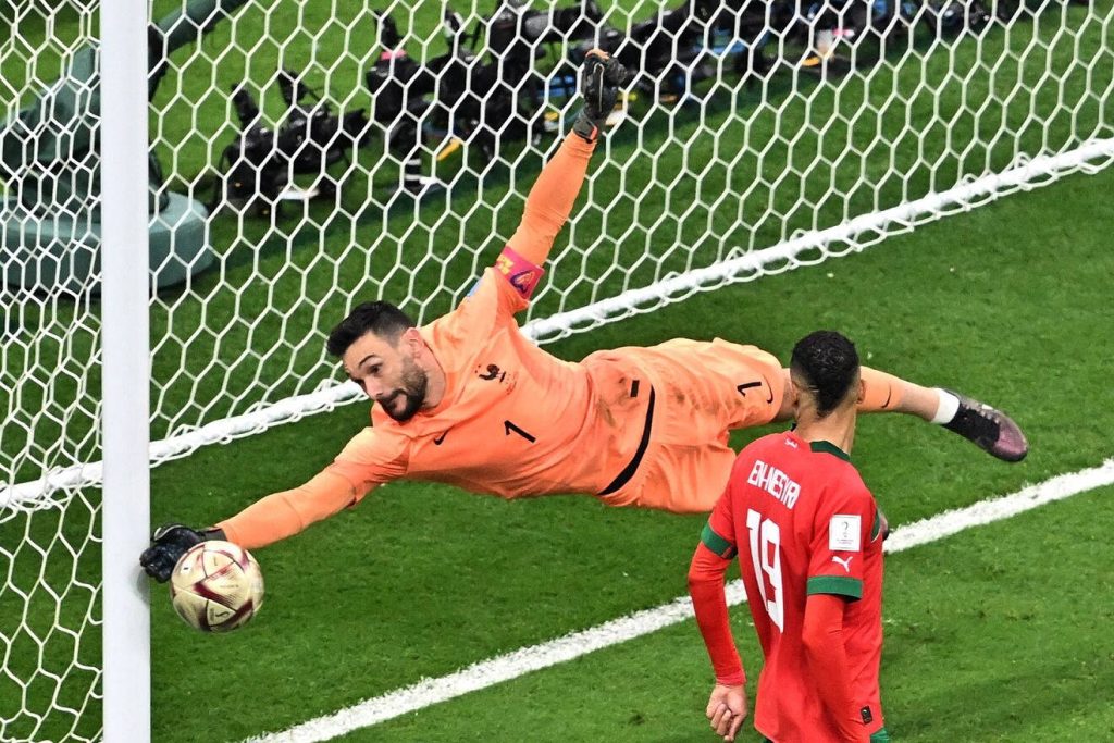 Hugo Lloris saves shot in World Cup match as Youssef En-Nesyri watches intense football action wallpaper