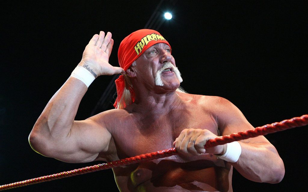 Hulk Hogan iconic wrestling pose red bandana intense presence dark ring wallpaper background