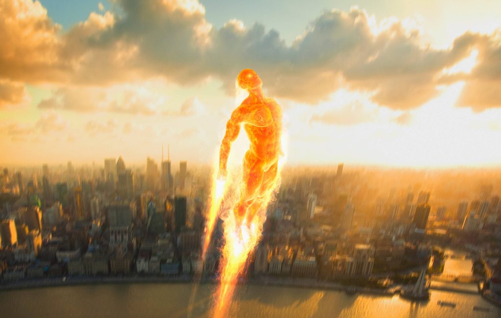 Human Torch flying over hazy cityscape at sunset blazing flames Fantastic Four wallpaper