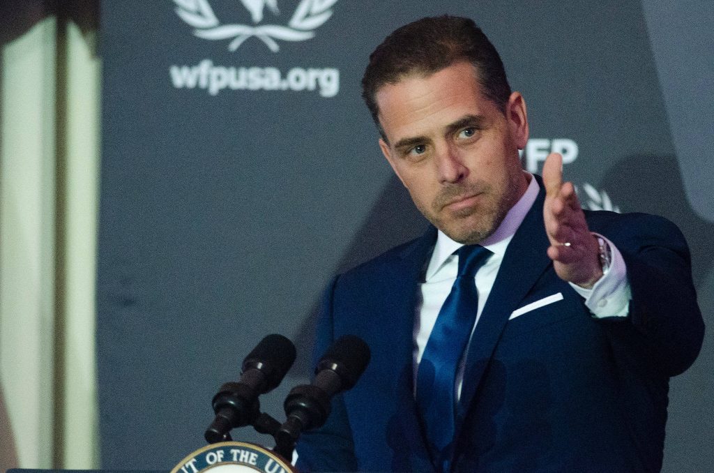 Hunter Biden speaking at World Food Program USA event in dark suit behind podium with microphones Wallpaper