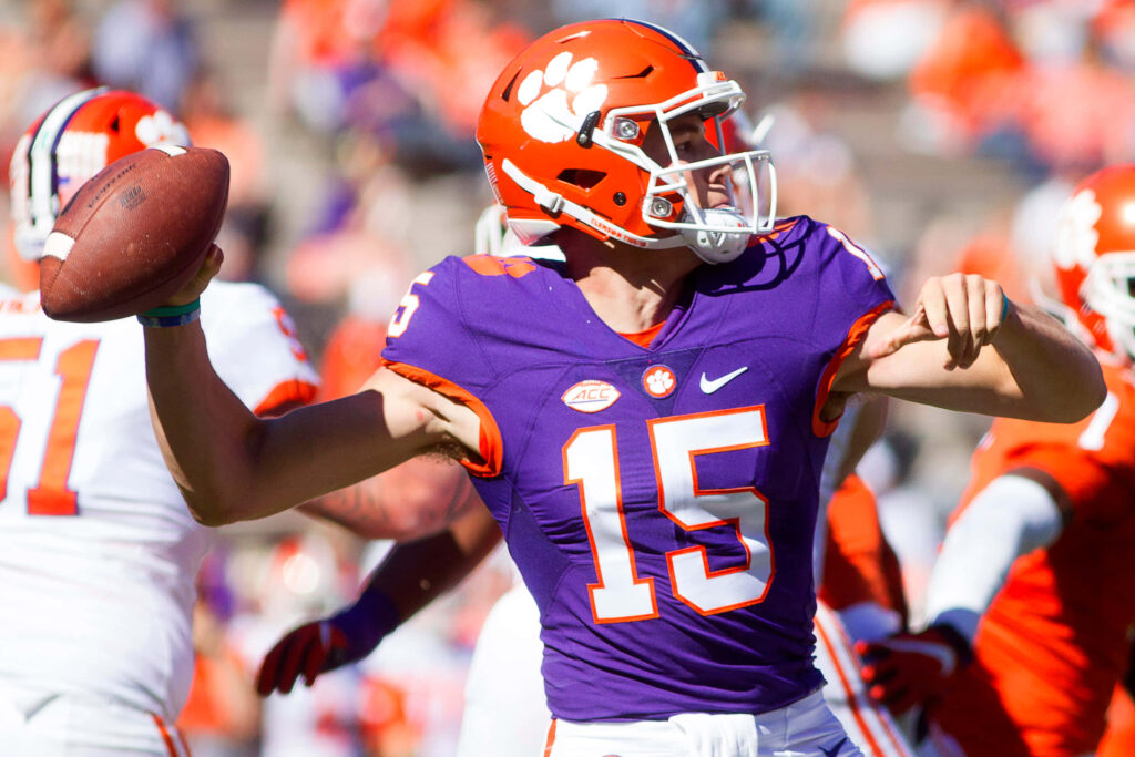Hunter Johnson Clemson Tigers football player in purple orange uniform ready to throw pass wallpaper