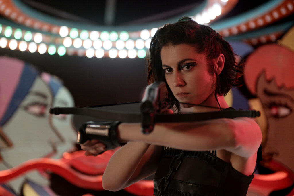 Huntress from Birds of Prey aiming crossbow intense focused vibrant colorful wallpaper background