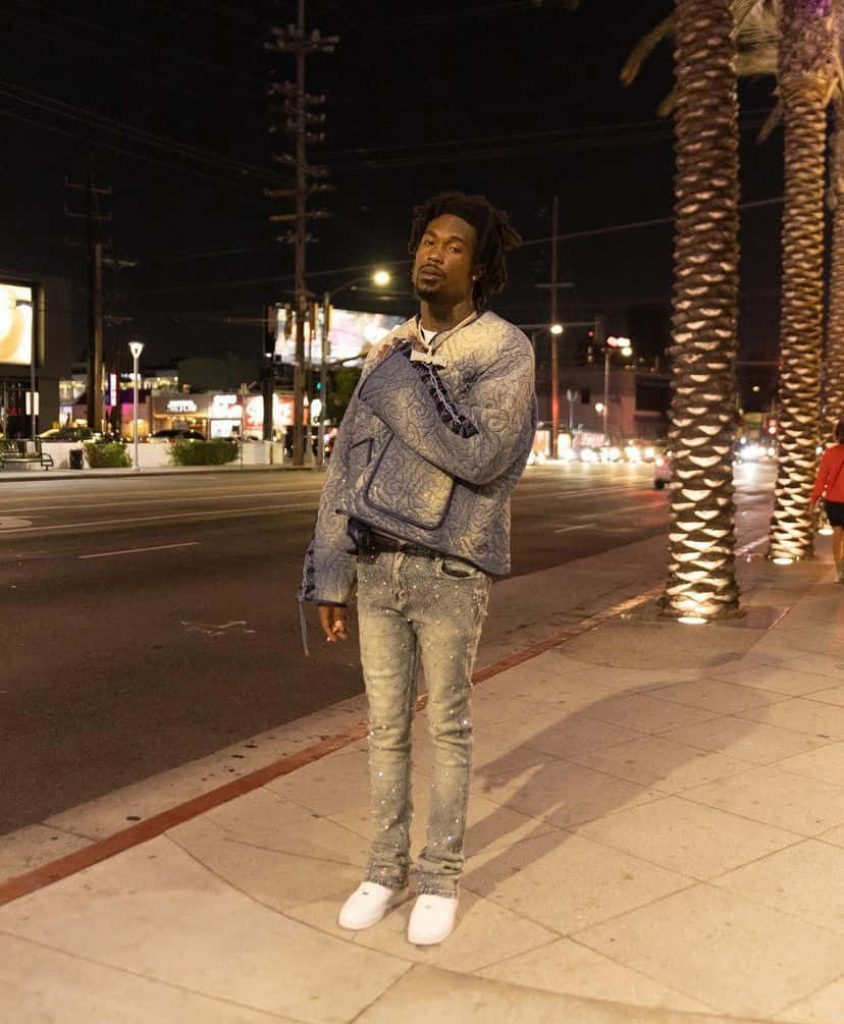 Rapper Hunxho urban night photo wearing blue jacket and distressed denim city street wallpaper