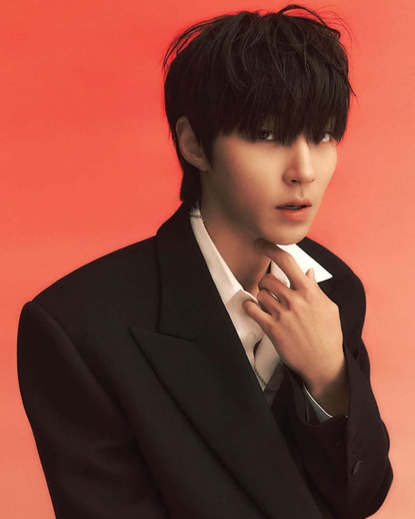 Studio portrait of actor Hwang In-youp in black blazer coral background True Beauty wallpaper