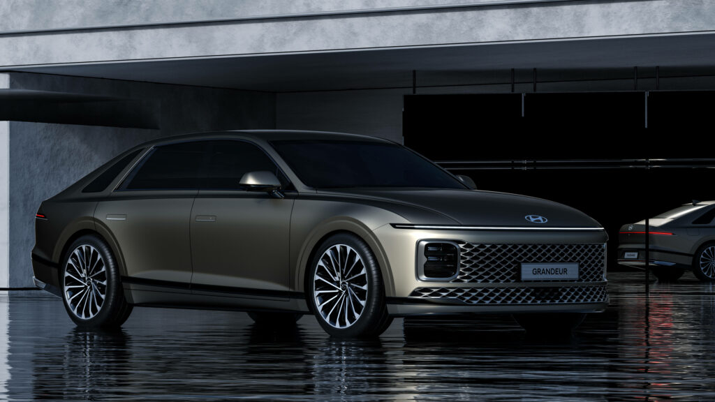 Grey Hyundai Grandeur car with sharp contours in modern setting on reflective floor high-resolution wallpaper