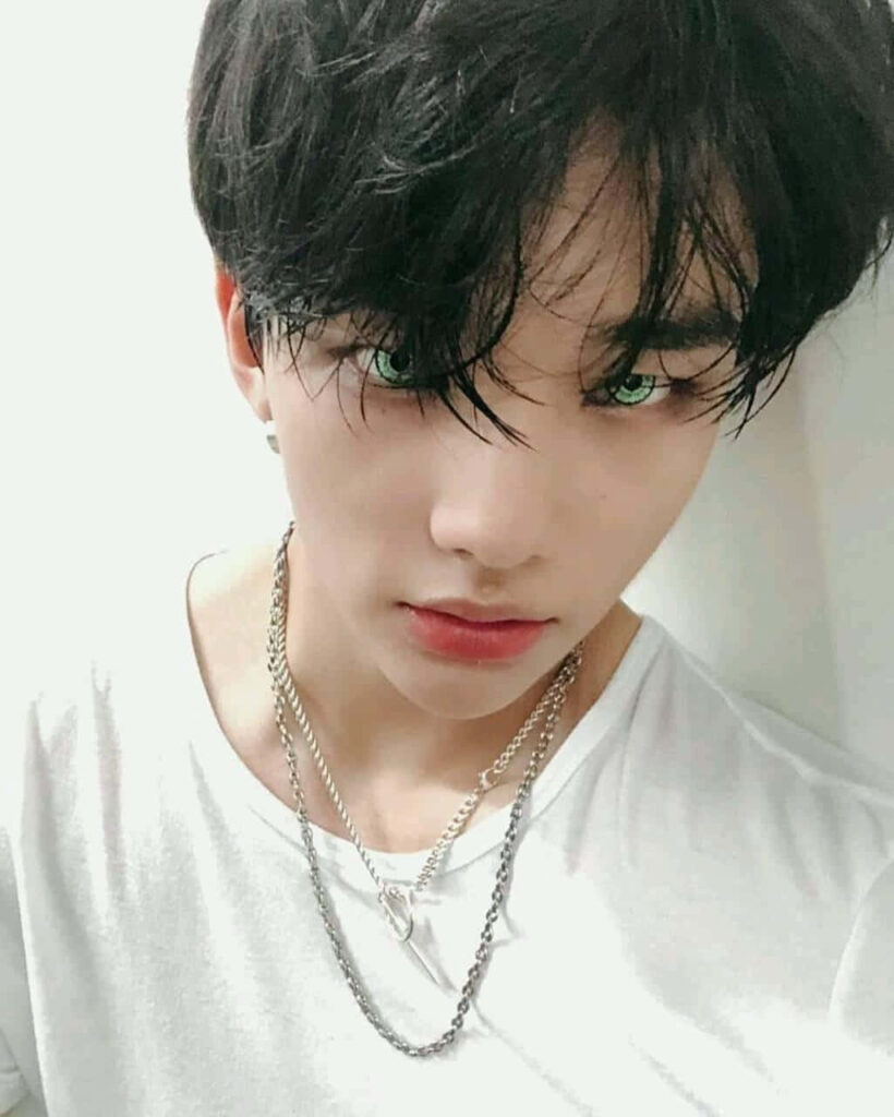 Hyunjin from Stray Kids with green contact lenses intense gaze edgy South Korean rapper wallpaper