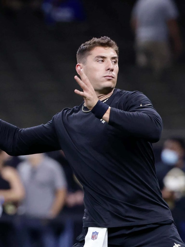 Ian Book NFL quarterback warmup throwing motion black gear stadium wallpaper background