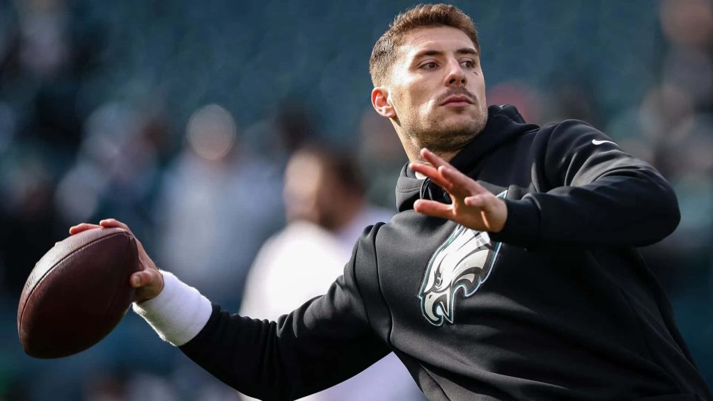 NFL wallpaper featuring Ian Book mid-throw in Philadelphia Eagles hoodie during warm-up session