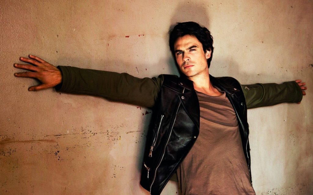 Ian Somerhalder stylish wall pose black leather jacket green sleeves intense gaze wallpaper