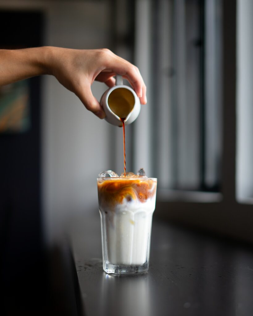 Iced Coffee Delight: Pouring Rich Brew Over Ice & Milk - Wallpaper