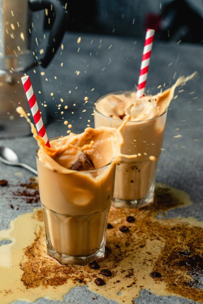 Iced Coffee Wallpaper: Vibrant Scene with Glasses, Straws & Beans