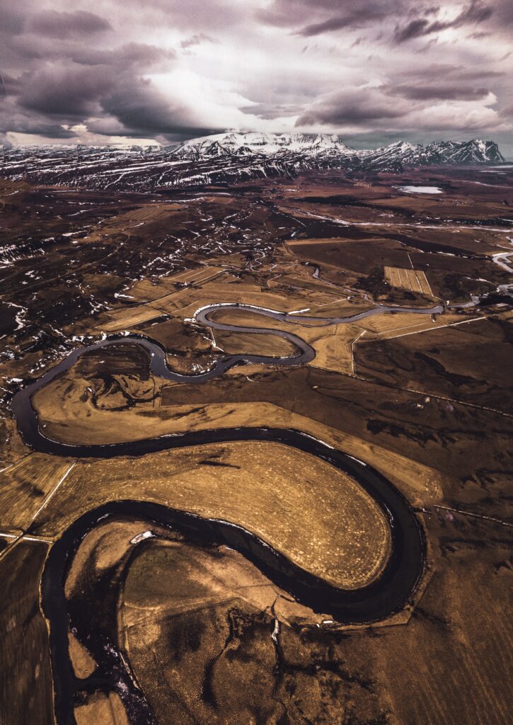 Aerial view of winding roads rivers and snow-capped mountains in Iceland winter landscape wallpaper