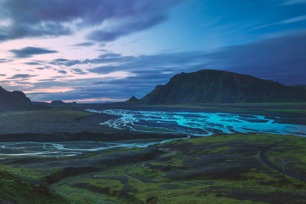Iceland braided rivers flowing through green valley with volcanic mountains dramatic landscape wallpaper