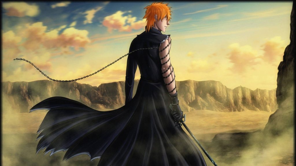 Ichigo Kurosaki in black Shinigami robes with chains stands in Hueco Mundo desert at sunset Wallpaper