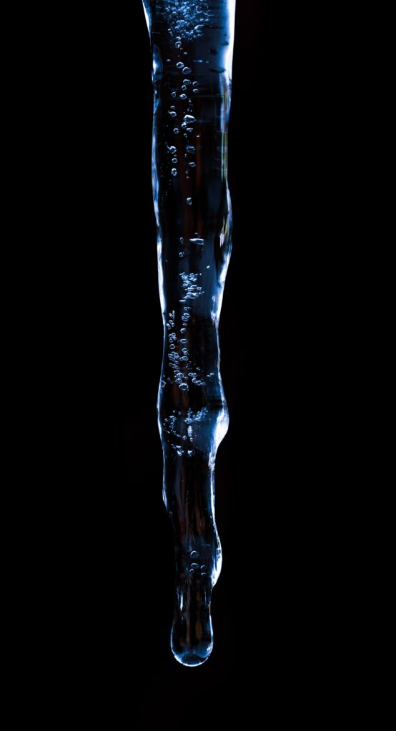 Intricate Icicle Macro: Stunning Frozen Details on Dark Wallpaper