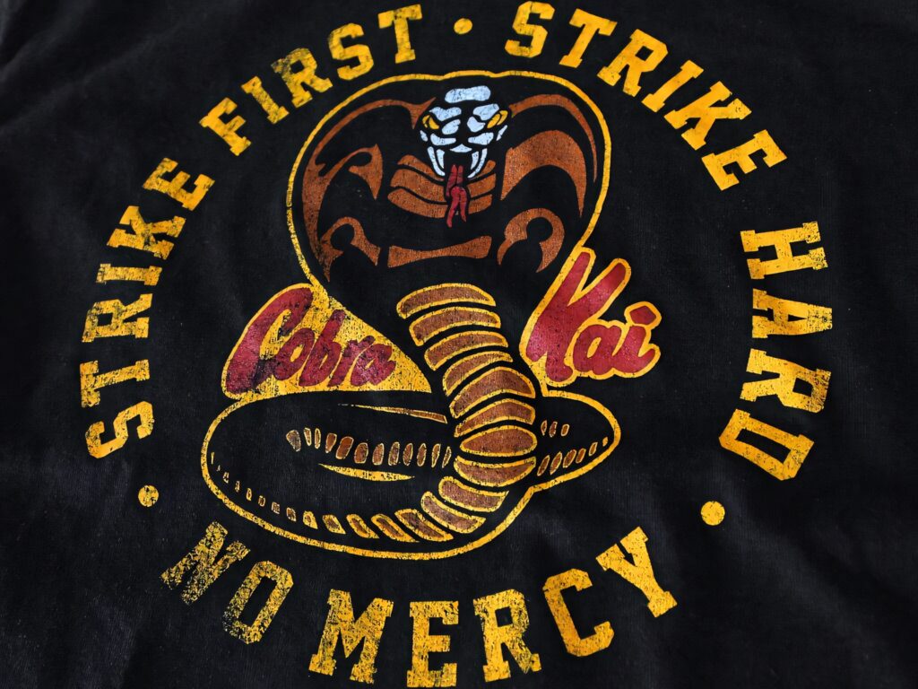 Cobra Kai Logo Wallpaper: Bold Strike First Design Background