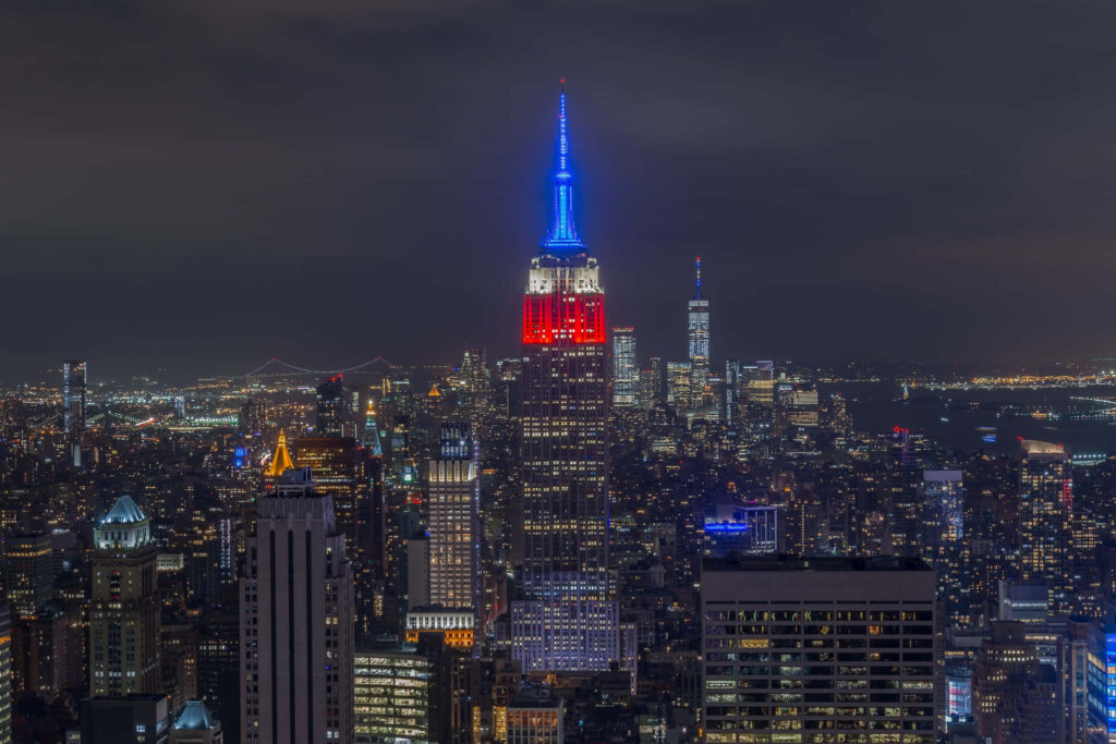 Radiant Illumination: A Captivating Nighttime Portrait of the Majestic Empire State Building Representing American Progress Wallpaper