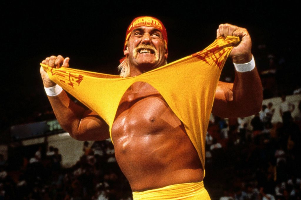 Hulk Hogan iconic wrestling moment tearing yellow shirt in red Hulkamania headband wallpaper