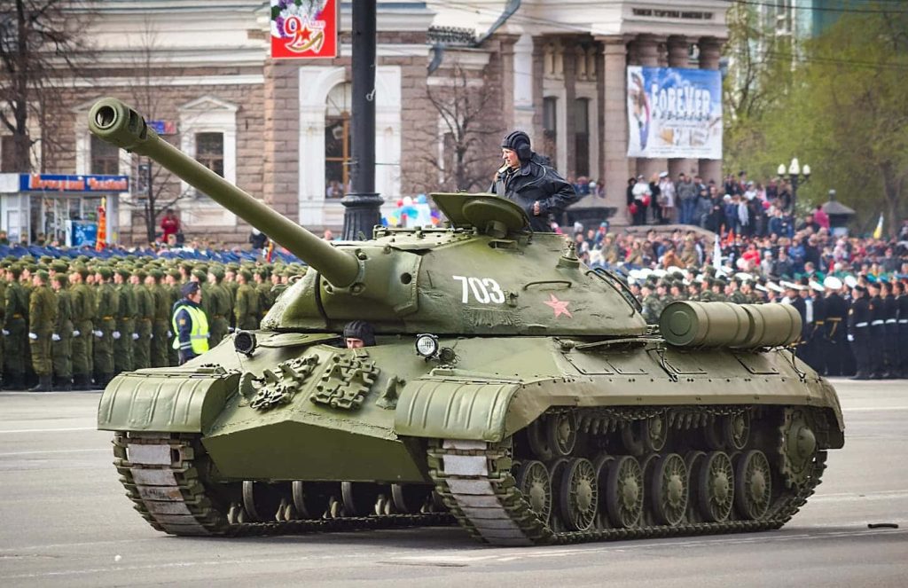 IS-3 heavy tank with pike-nose armor and 703 markings at military parade wallpaper background