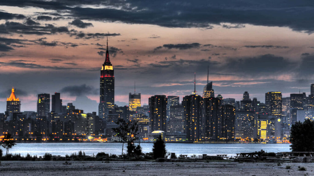 Manhattan Majesty: The Iconic Empire State Building Pierces the Skyline with Its Art Deco Splendor Wallpaper