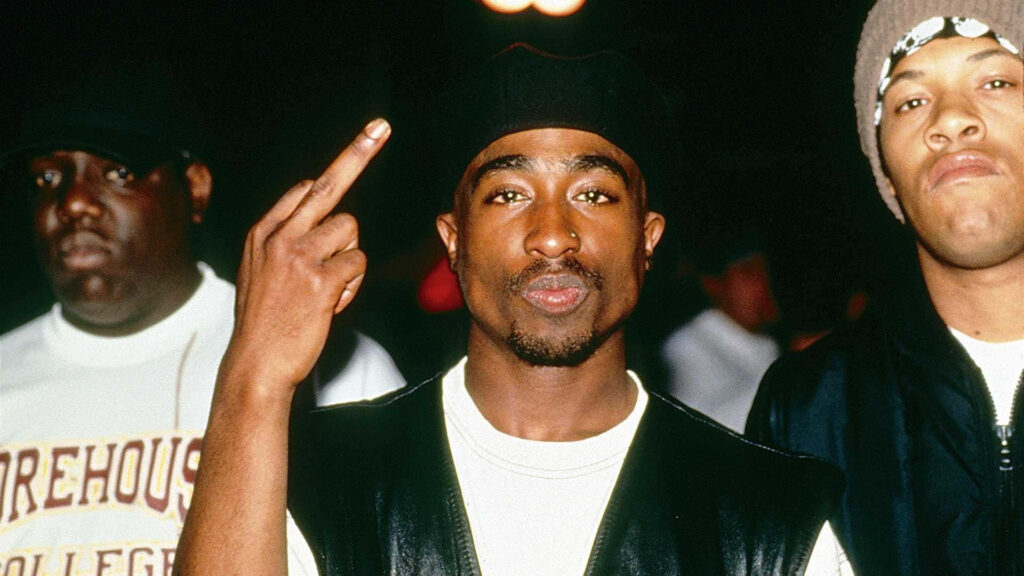 Unforgettable Encounter: Legendary Rap Icons 2Pac and Biggie Smalls Strike a Pose in Captivating Backdrop Wallpaper