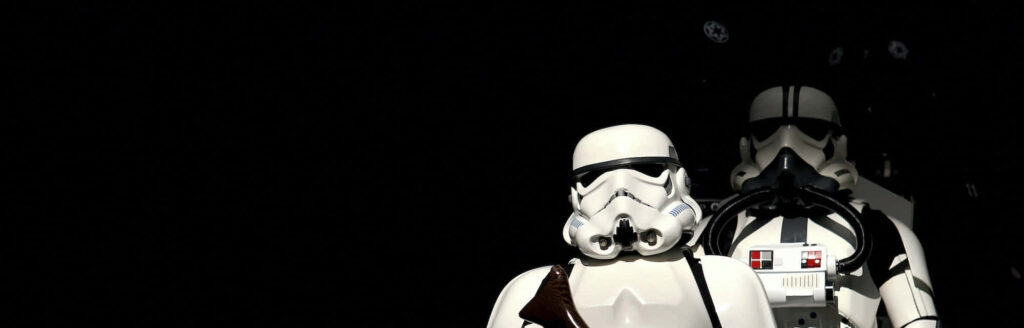 Minimalist Star Wars Wallpaper: Iconic Stormtroopers on Dark Background