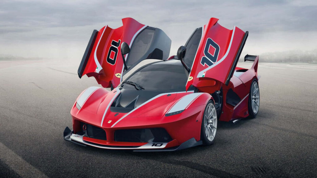 Racing in Style: Captivating Action Shot of a Sleek Red Ferrari Speeding through the Race Track Wallpaper