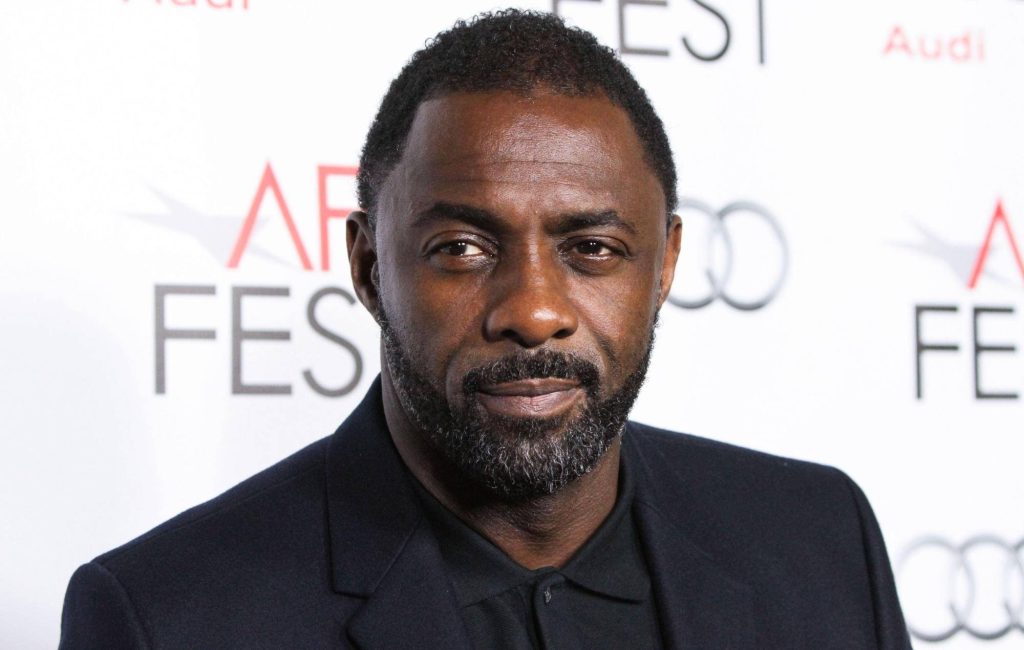 Idris Elba in black blazer at 2013 AFI Fest professional portrait with white branded backdrop Wallpaper