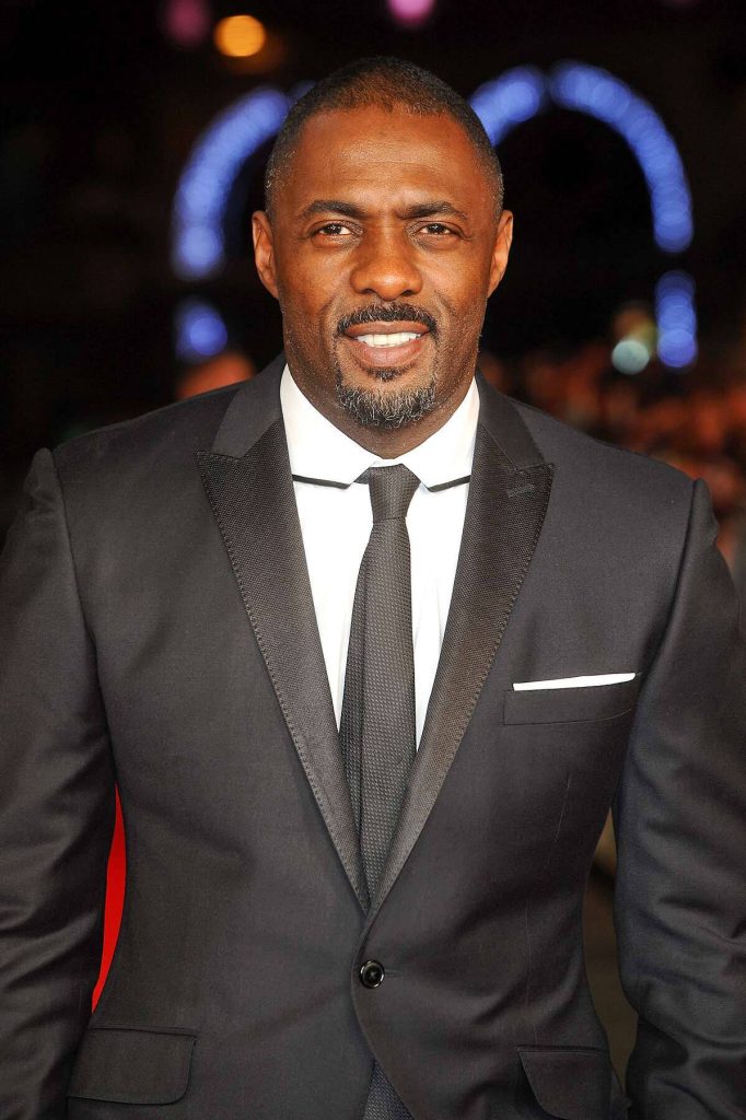 Idris Elba in black tuxedo smiling at Royal Film Performance Mandela Long Walk to Freedom Wallpaper