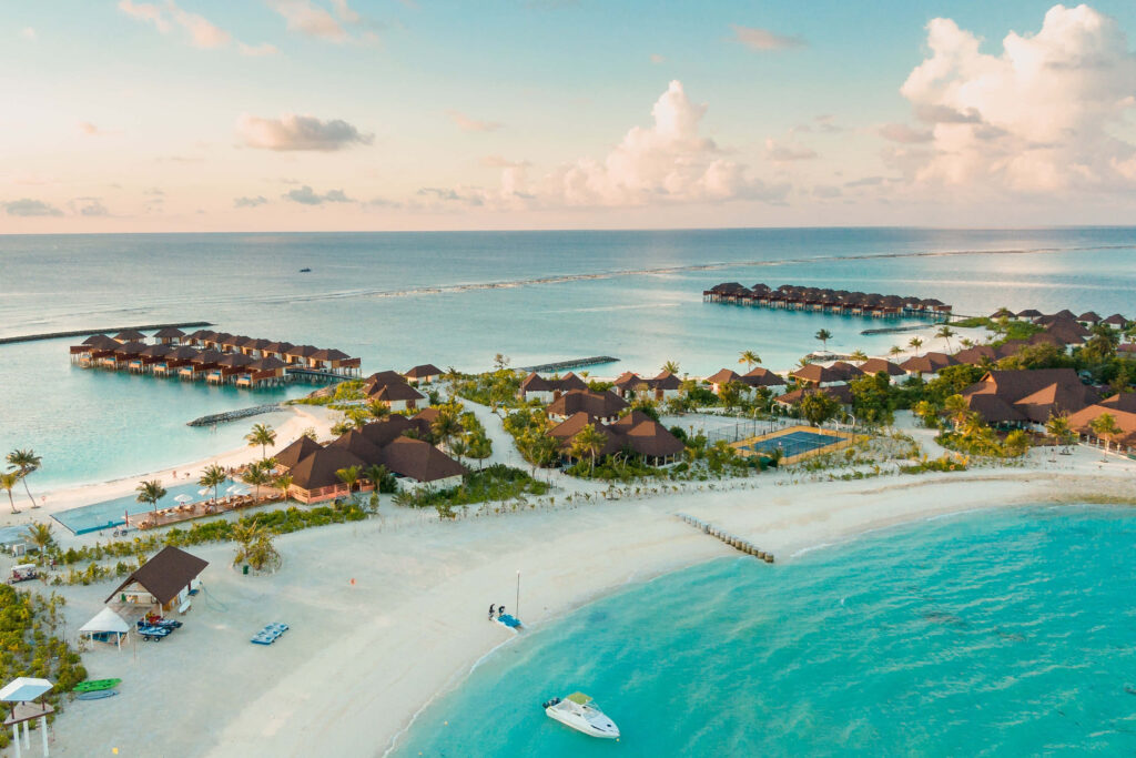 Idyllic Beach Wallpaper with Turquoise Waters and Overwater Bungalows