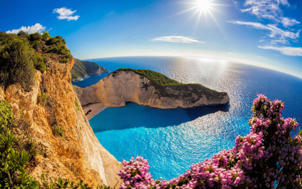Idyllic Coastal Paradise: Azure Waters & Rugged Cliffs Scene Wallpaper