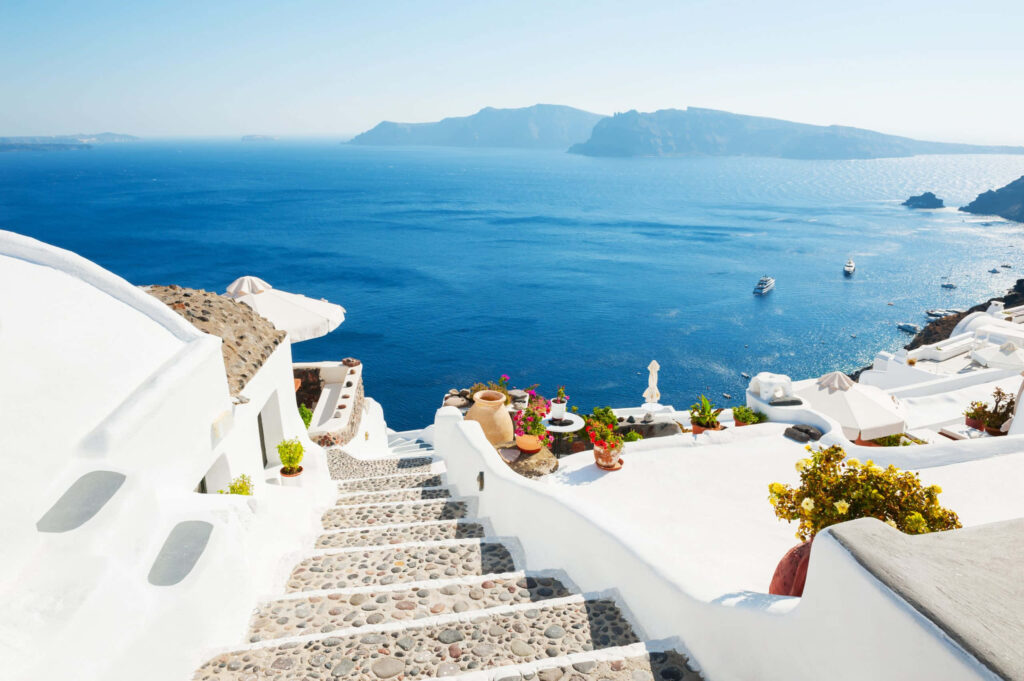 Serene Greek Beach Wallpaper: White-Washed Architecture & Azure Sea