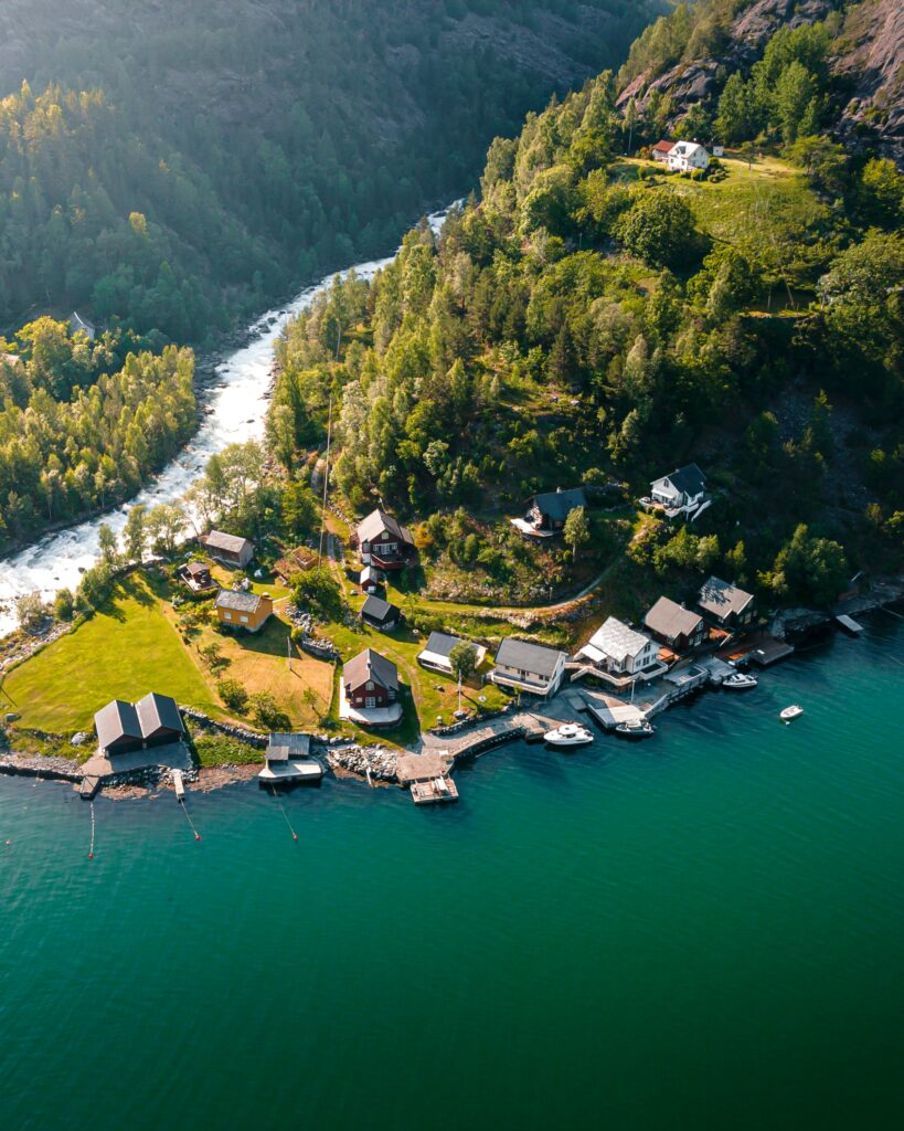 Idyllic rural retreat with cozy houses wooden docks lush green hills winding river coastline wallpaper
